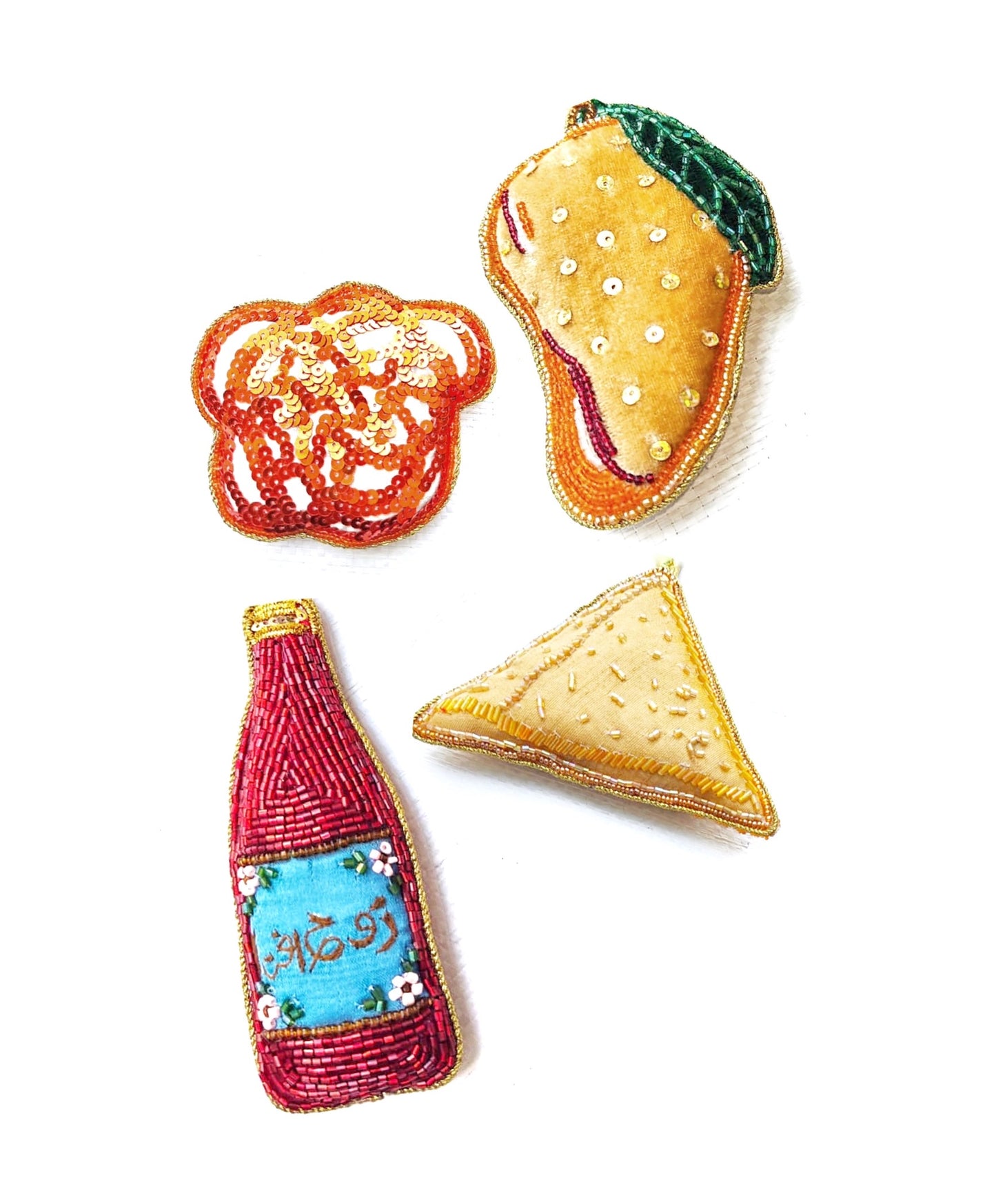 A set of handcrafted garland ornaments with symbols representing South Asian culture, including an orange mango, a blue and white rooh afza drink, a samosa, and a yellow and green jalebi.