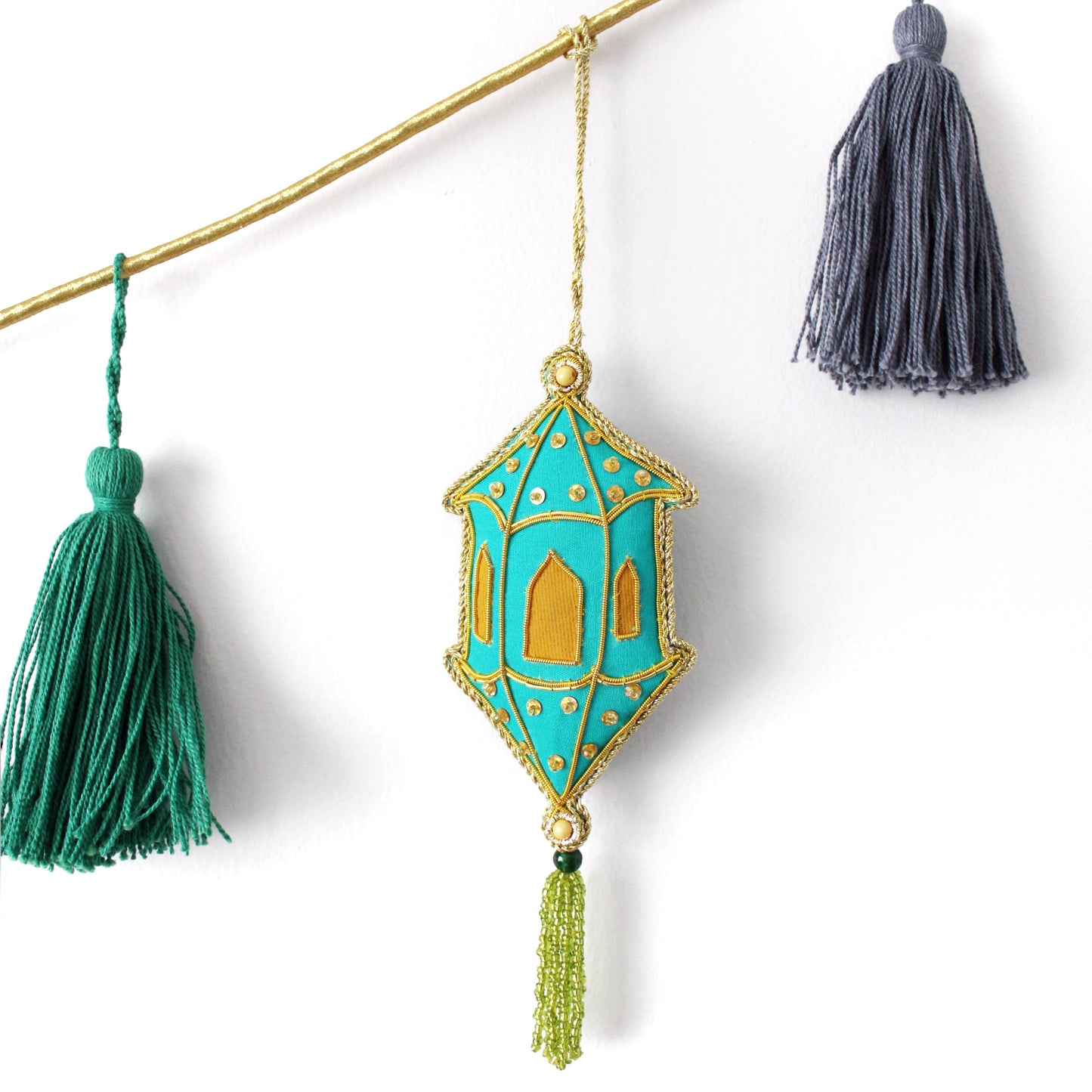 Decorative hanging ornament with tassels on a white background