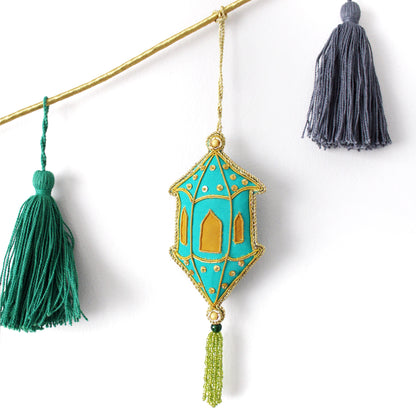 Decorative hanging ornament with tassels on a white background